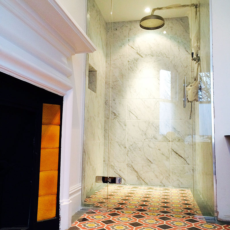 Frameless glass shower by fireplace in Richmond, London