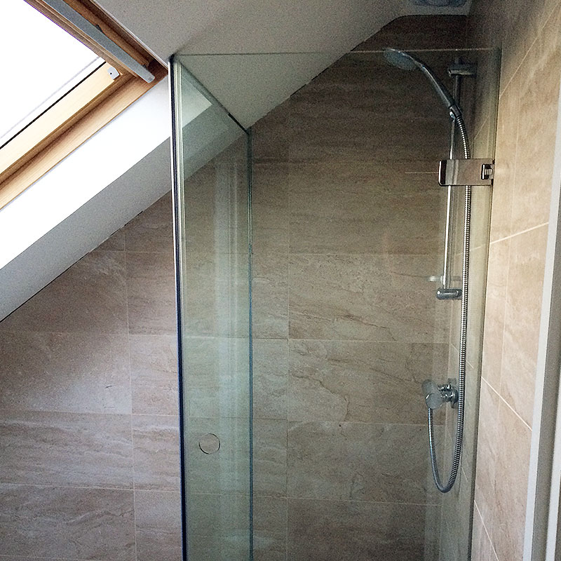 Frameless glass shower in West London which fits in with alignment of sloping roof