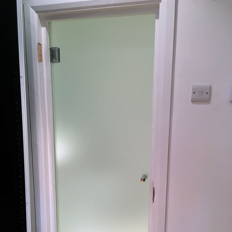 Frosted glass treatment room door in London