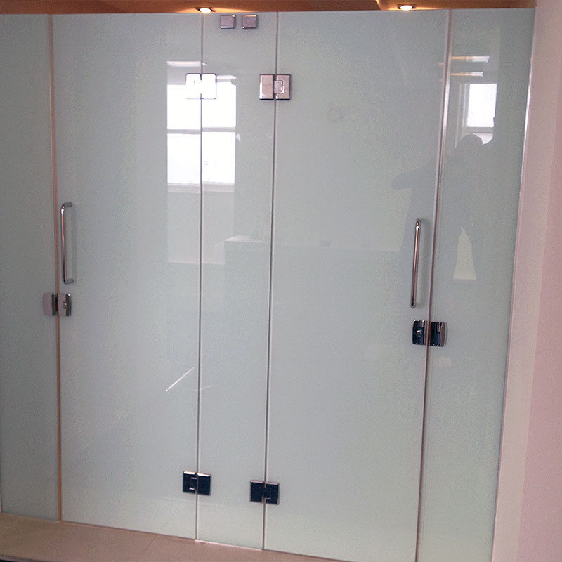 Coloured glass shower and toilet doors at a gym in London