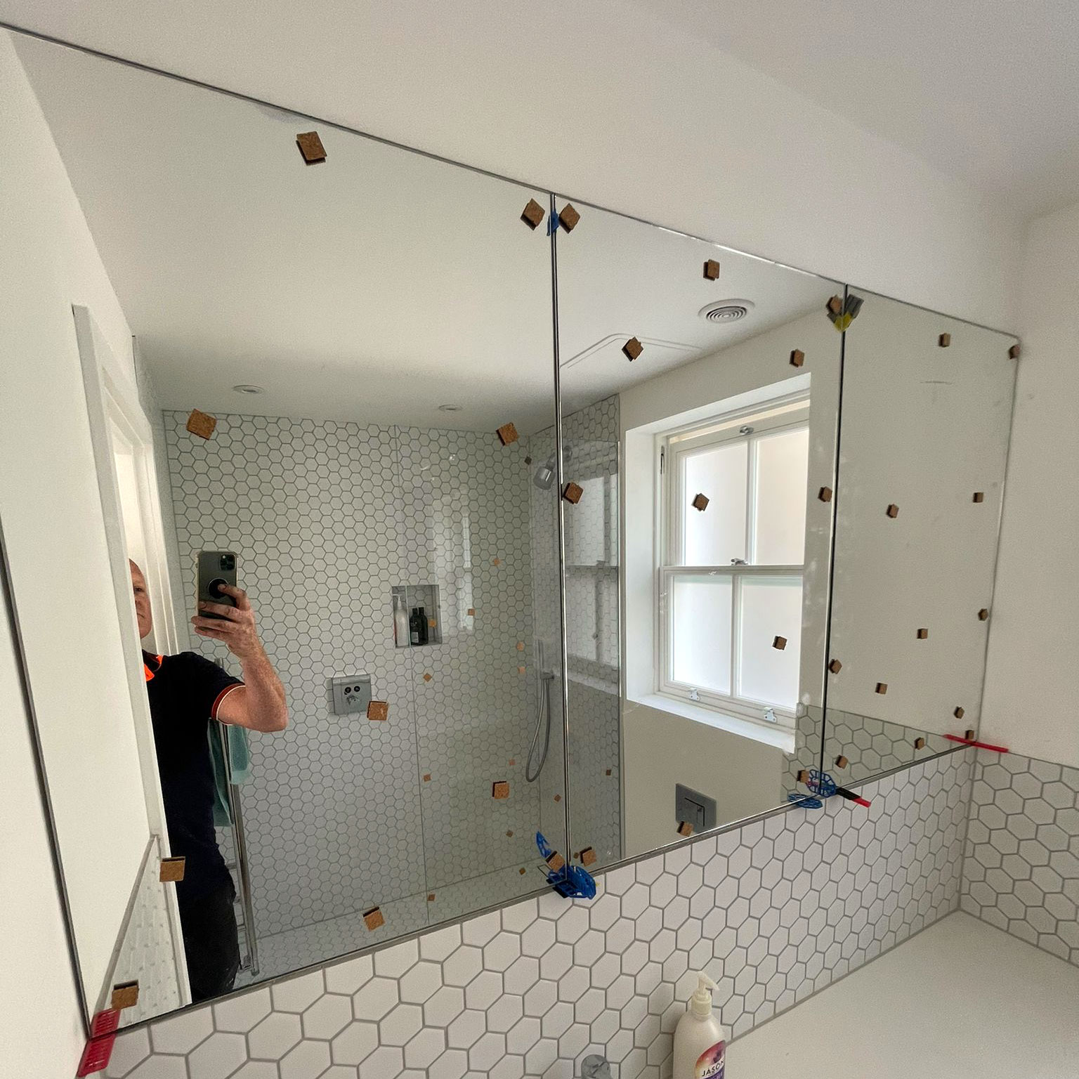 Bespoke bathroom mirror being fitted