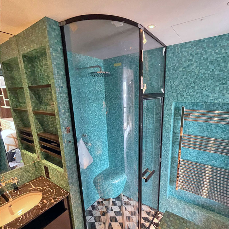 Curved frameless glass shower enclosure