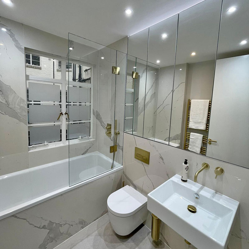 Frameless glass shower, bespoke mirrors and frosted glass on window