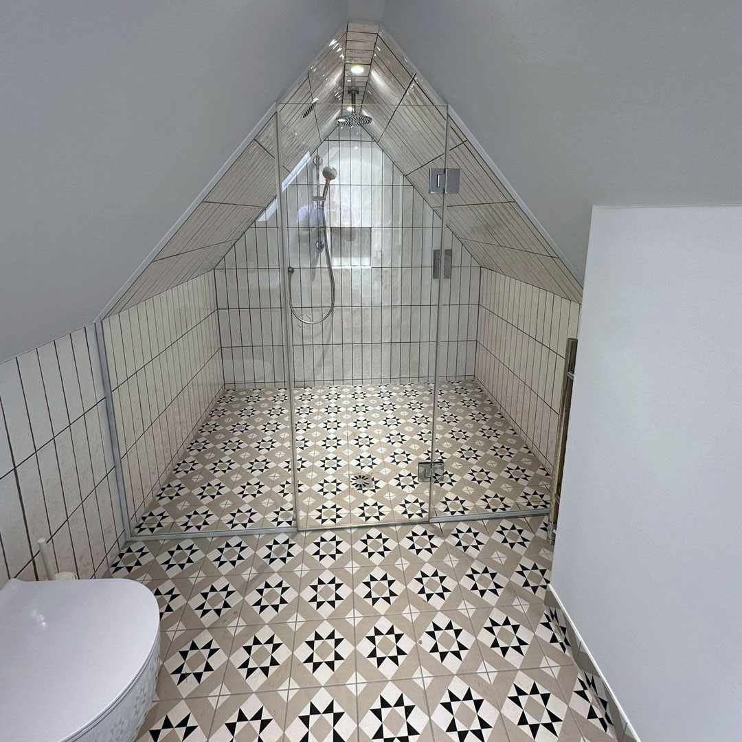 A shaped wet room panel and doors designed to fit flush with the ceiling of this attic room in Notting Hill