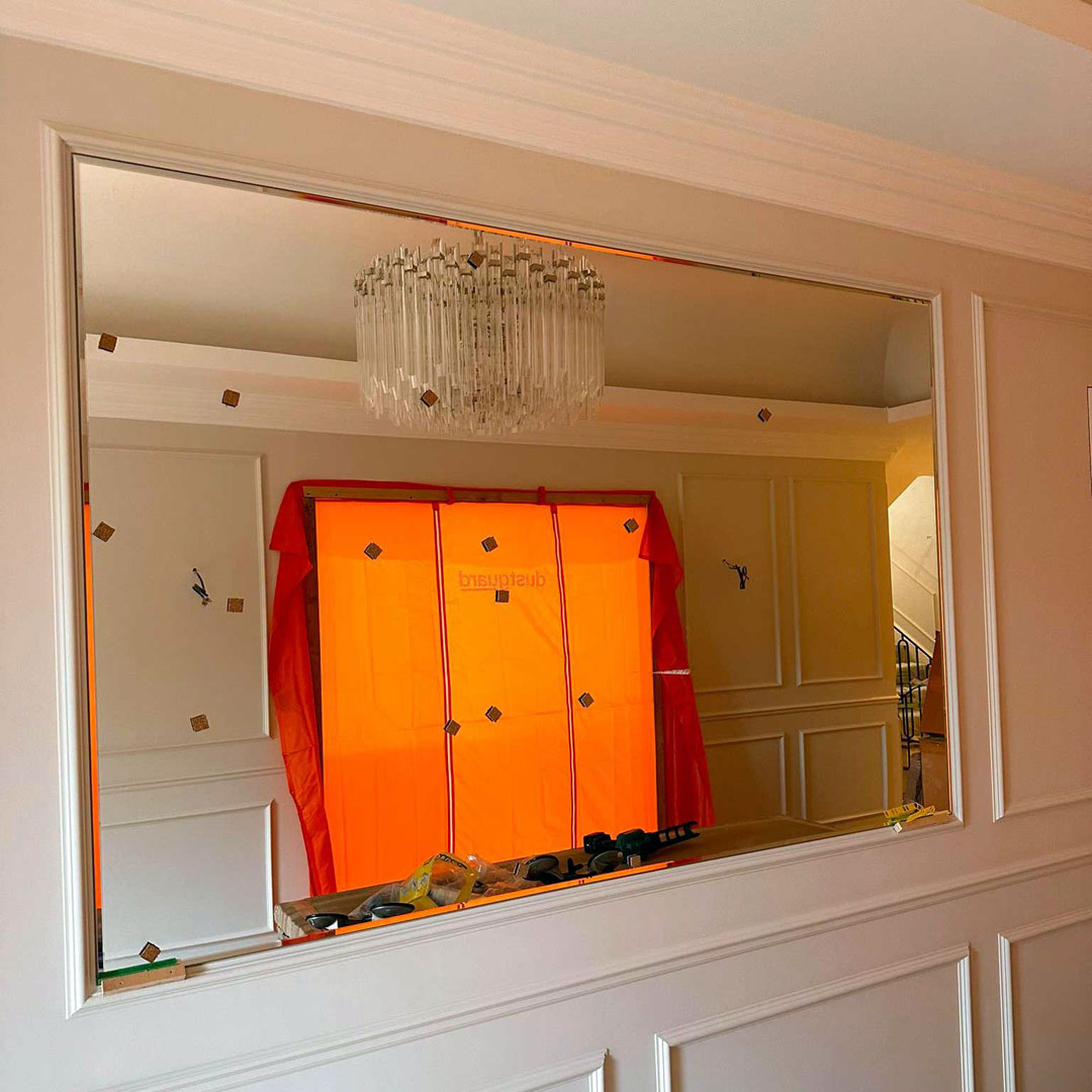A new large wall mirror installation in progress in West London