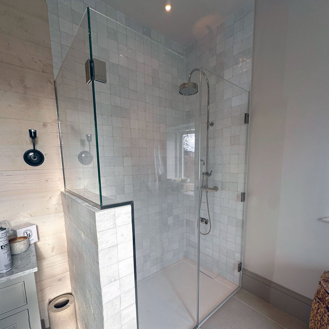 A glass shower surround with integrated wall